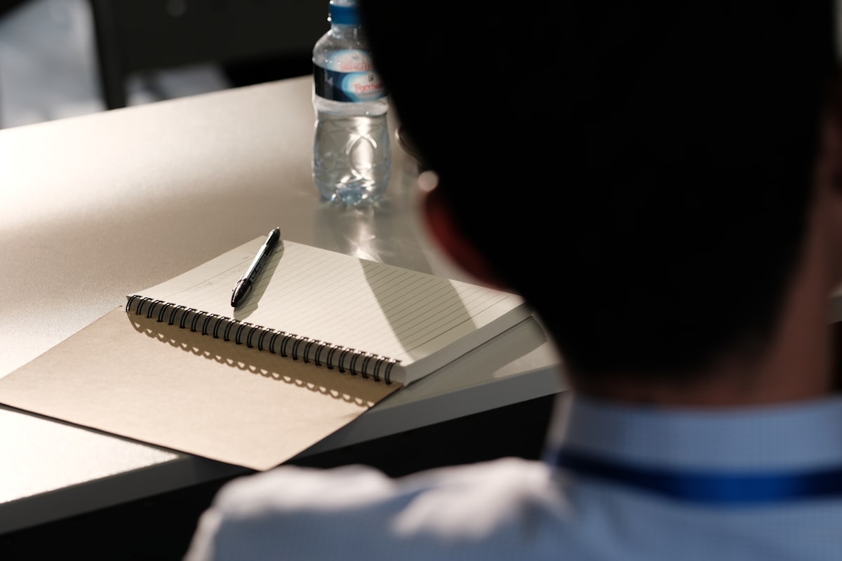 Notebook and pen on a desk — IBPS PO 2026 banking exam preparation