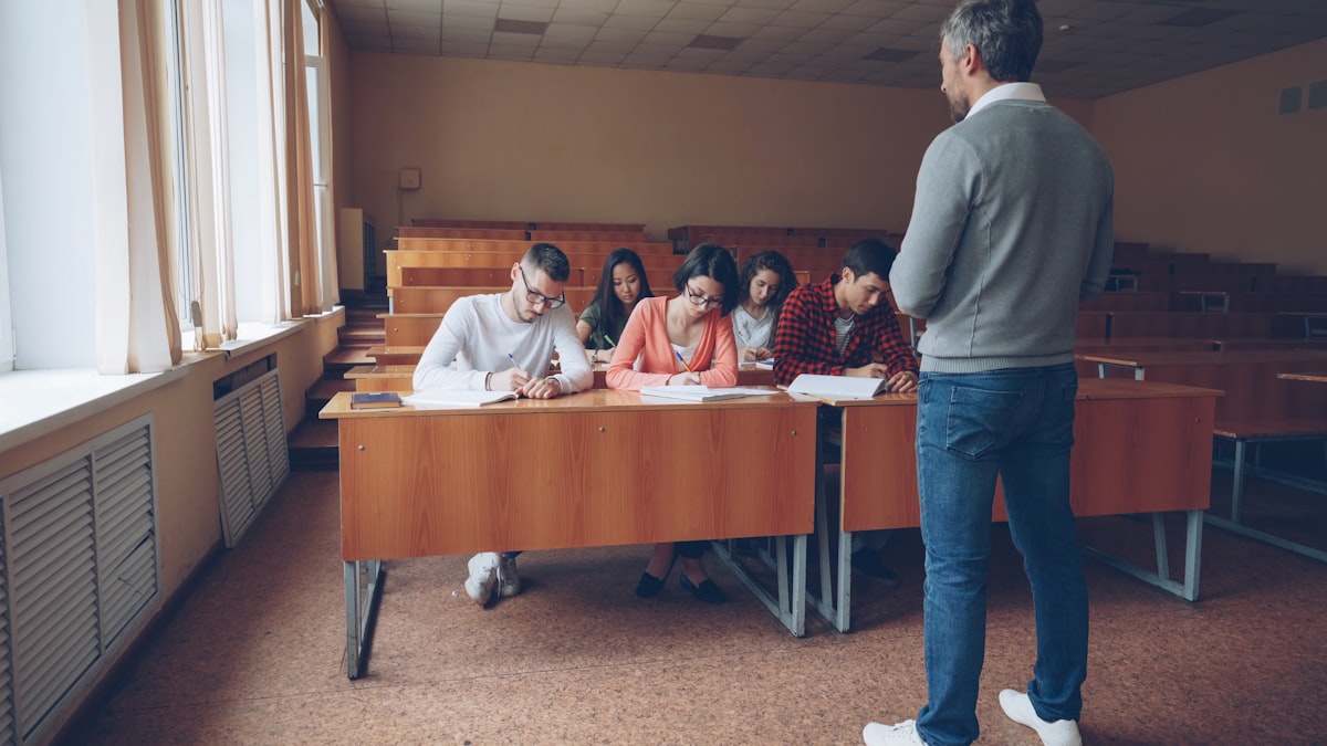 Students writing an exam in a hall — RRB NTPC Graduate CBT preparation