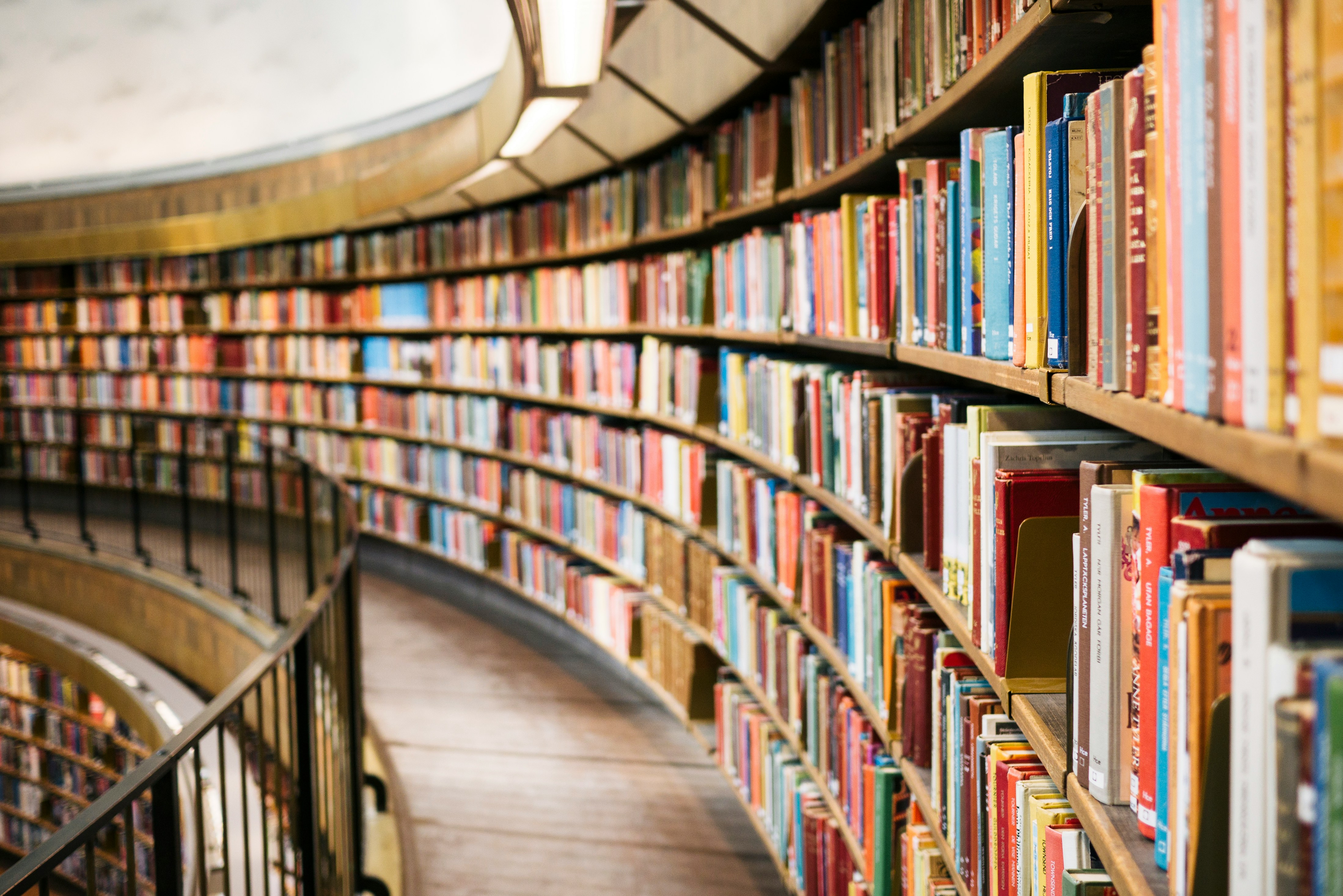 Library bookshelves curving — representing the breadth of UPSC Civil Services preparation